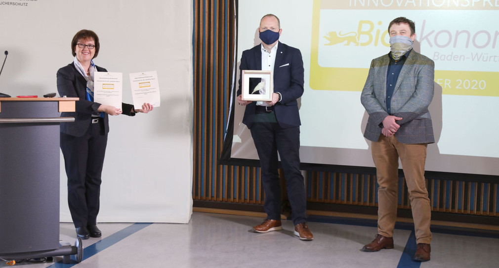 Ministerialdirektorin Grit Puchan (l.) überreicht die Urkunde zum Innovationspreis Bioökonomie an Dietmar Böhm von der OutNature GmbH (2.v.r.) und Simon Rauch vom Energiepark Hahnennest (r.) 